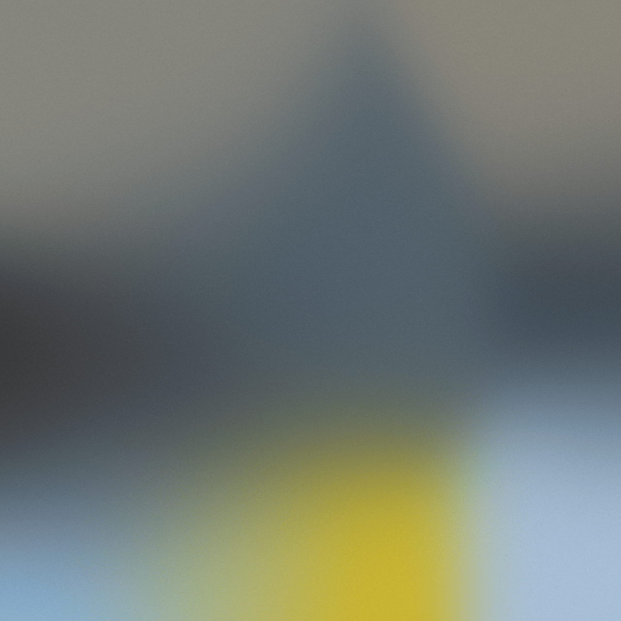 Abstrakte Unschärfe in Grau, Blau, Gelb und Hellblau.